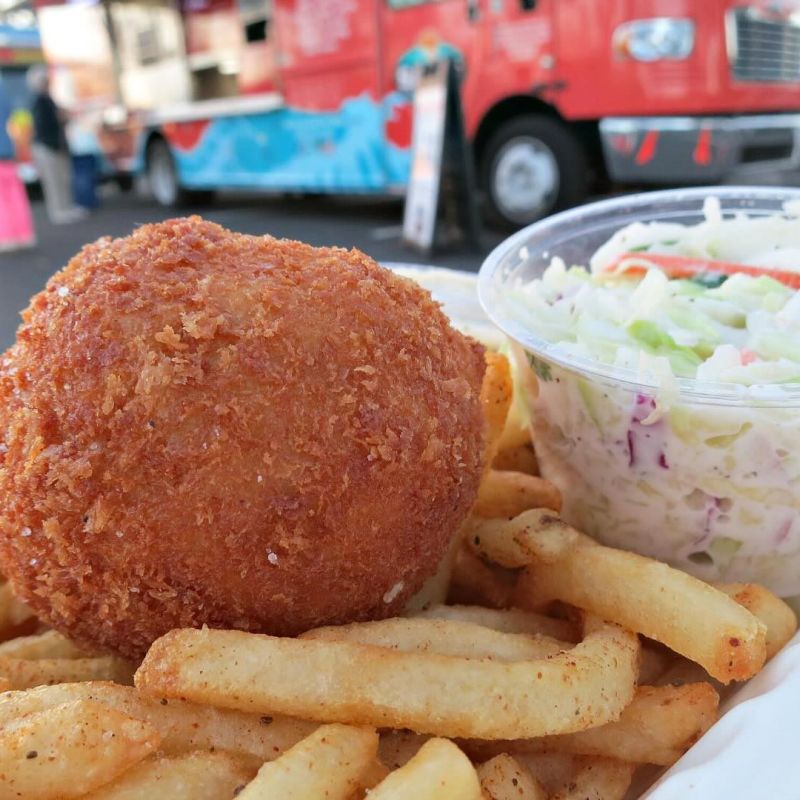 Crispy Crab Cake with Old Bay Fries and Coleslaw and Sam's ChowderMobile with line of patrons in background