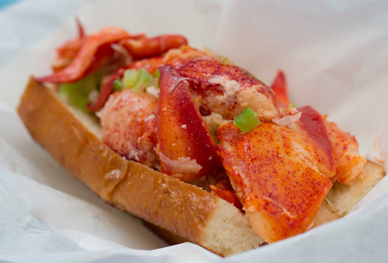 lobster roll sandwich with Maine lobster lightly tossed in warm butter on toasted bun from Sam's ChowderMobile